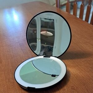 Compact Double-Sided Mirror with Magnification